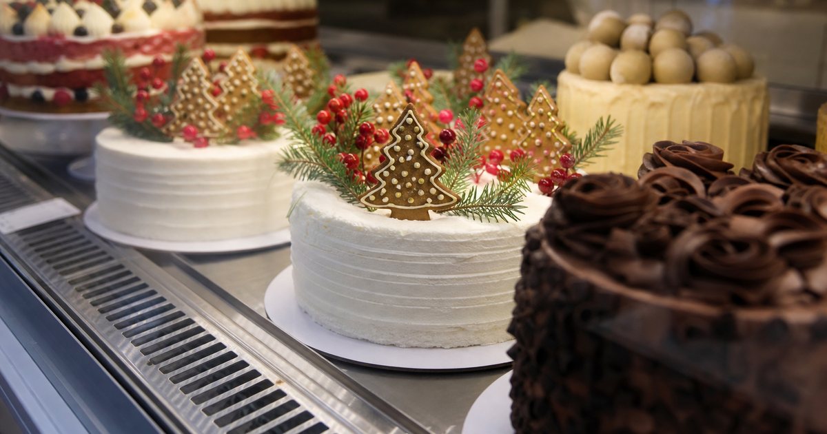 How can a small bakery handle a flood of custom cake orders during a busy holiday season?